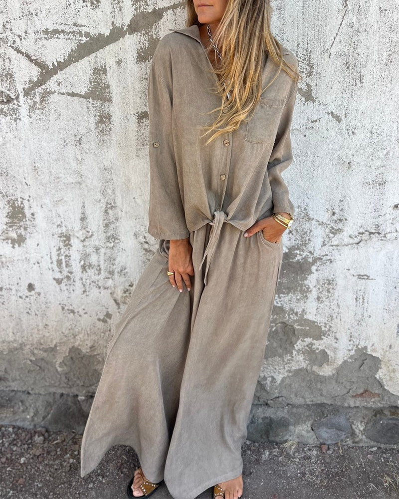 Elegant ladies summer outfit with baggy pants and long-sleeved button-up blouse