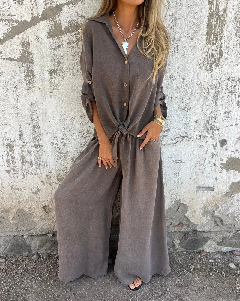 Elegant ladies summer outfit with baggy pants and long-sleeved button-up blouse