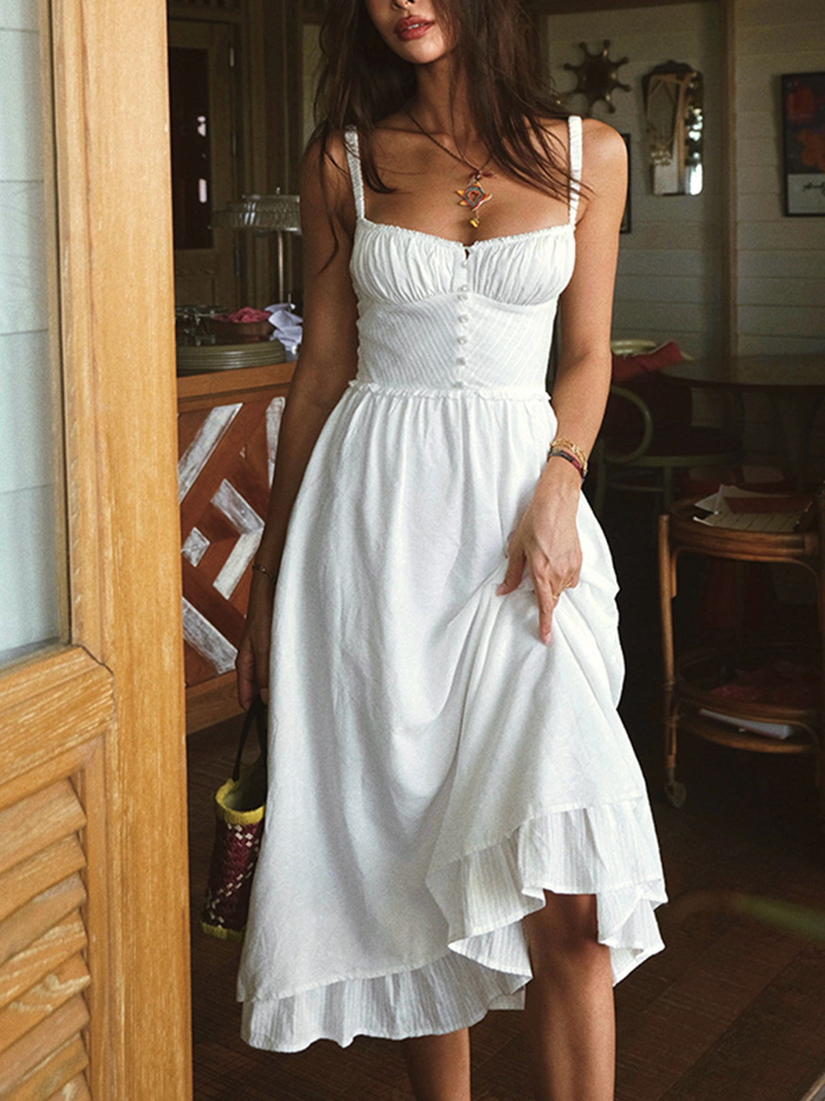 Elegant midi dress with straps and hem with ruffles