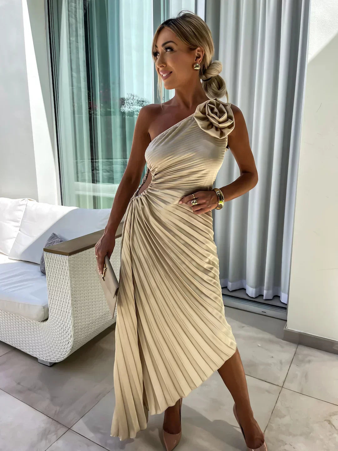 Long party dress with pleats and asymmetrical design with floral details