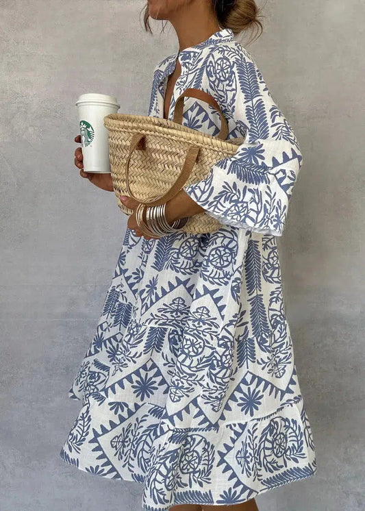 Bohemian-style short dress with V-neckline and three-quarter sleeves
